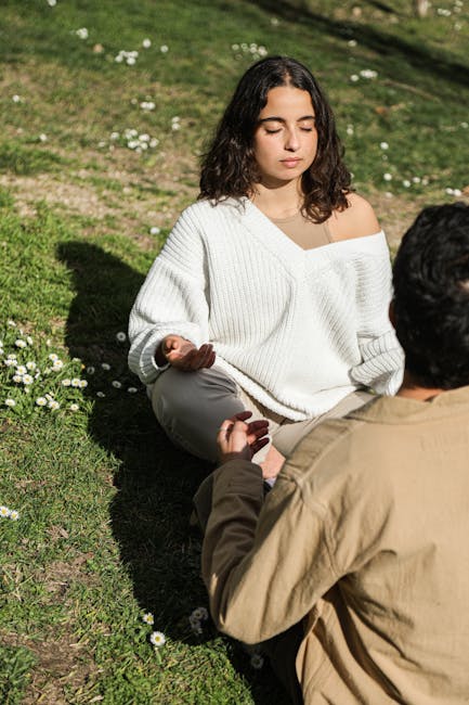 Man sitting in a meditative yoga posture in a bright room